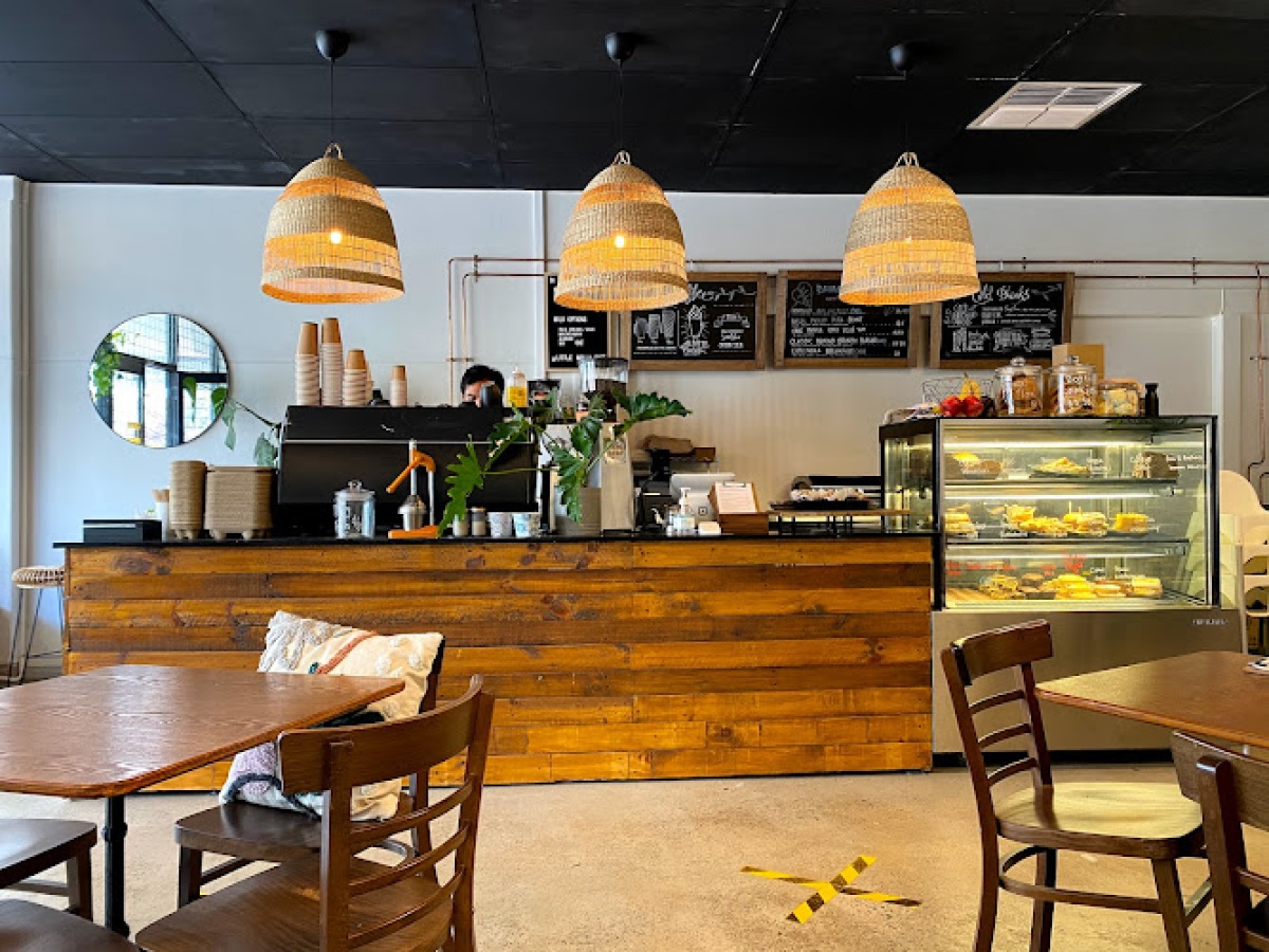 Little Nolla’s timber counter, woven pendant lights and leafy café interior